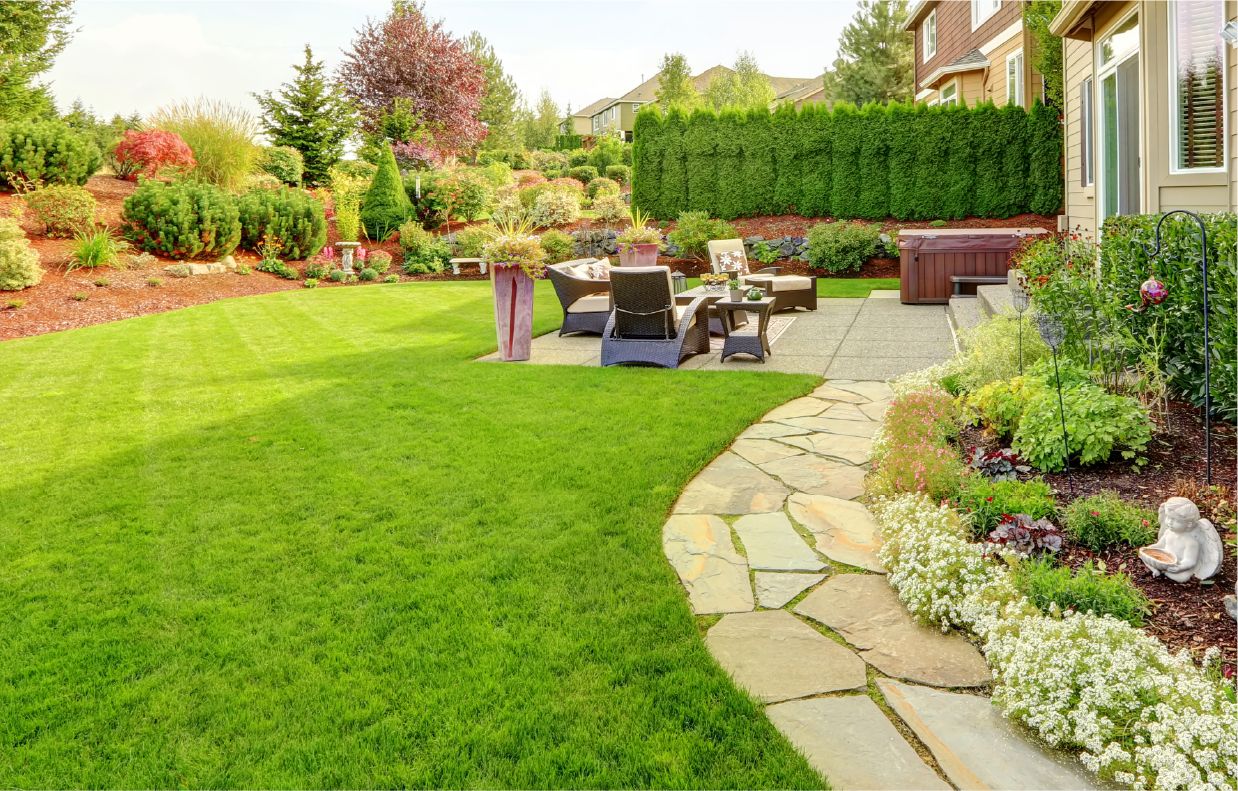 back yard with amazing landscaping, small garden, and seating area